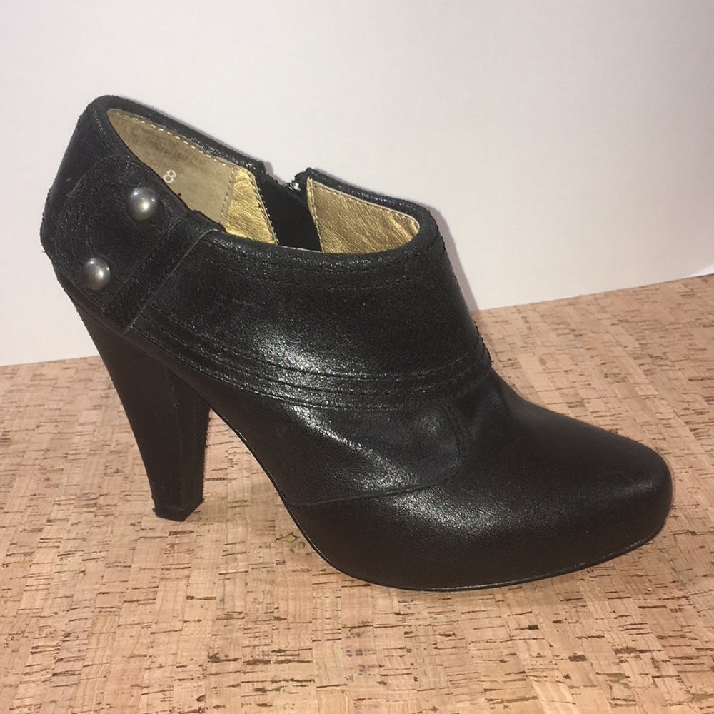 Black leather ankle bootie with gunmetal studs.